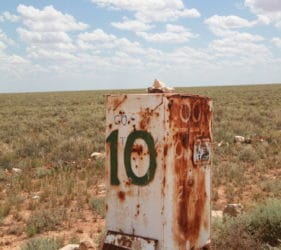 Rusty box road marker on Cook Road, 10Km to Cook