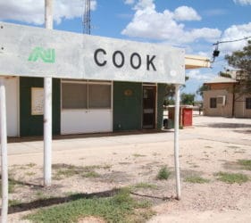 Station masters office in front of Cook Railway Sign