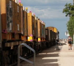 Leonie walking alongside the Pacific National NR2 arriving at Cook from the west