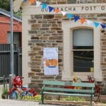 Bike art and poster of Lesley the Postmaster at the Gumeracha Post Office for the Tour Down Under