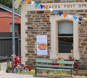 Bike art and poster of Lesley the Postmaster at the Gumeracha Post Office for the Tour Down Under