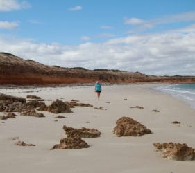 Leonie walking on the beach at the Bamboos