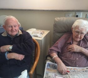 Leonie's Dad (left) and his brother Jack tackling a word puzzle in Gumeracha Hospital