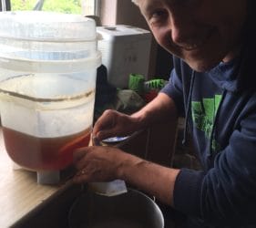Vic filtering out the sediment from the Fermenting Vessel